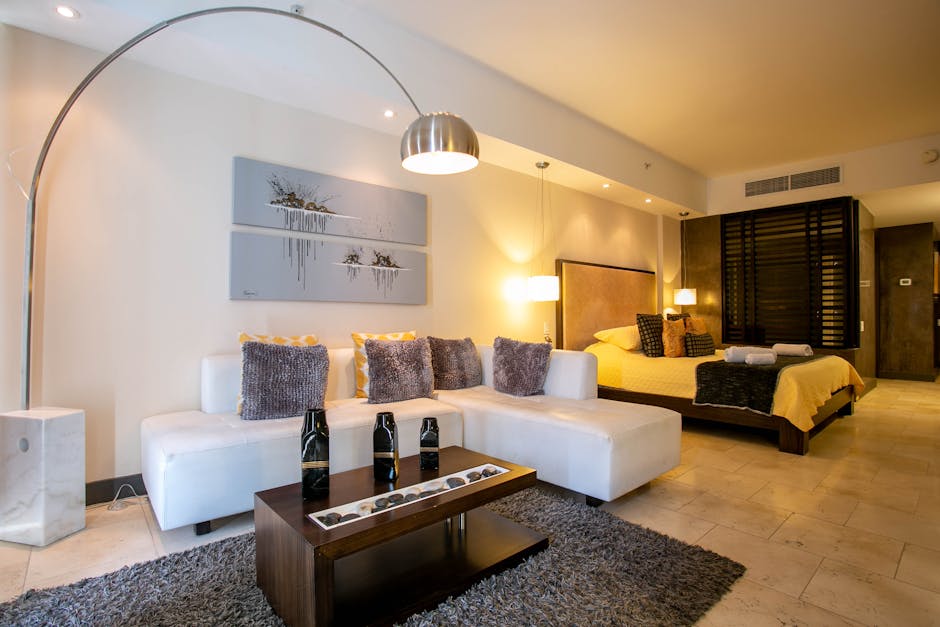 A luxurious hotel suite showcasing distinct zones and custom furniture expertly integrated into its expansive hotel room layout and dimensions.