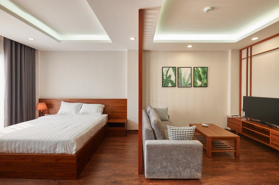 A modern and minimalist dual-space room featuring a sleek bedroom and cozy living area.