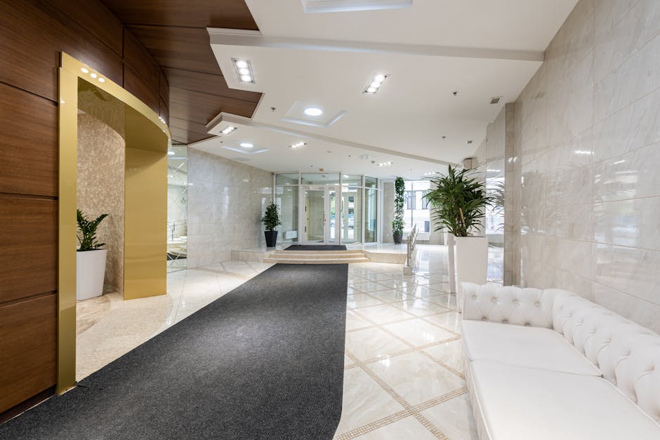 A modern luxury hotel guest room with integrated smart technology in the hotel furniture, including wireless charging and discreet lighting.