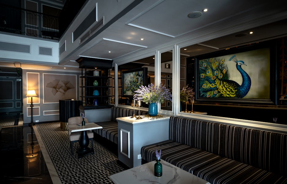 Luxurious hotel lobby featuring opulent decor, art, and comfortable seating for guests.