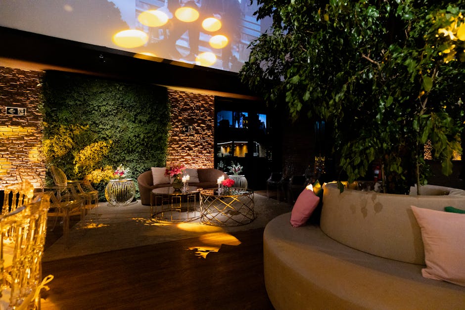Luxurious indoor lounge with stylish seating, modern lighting, and greenery accentuating the space.