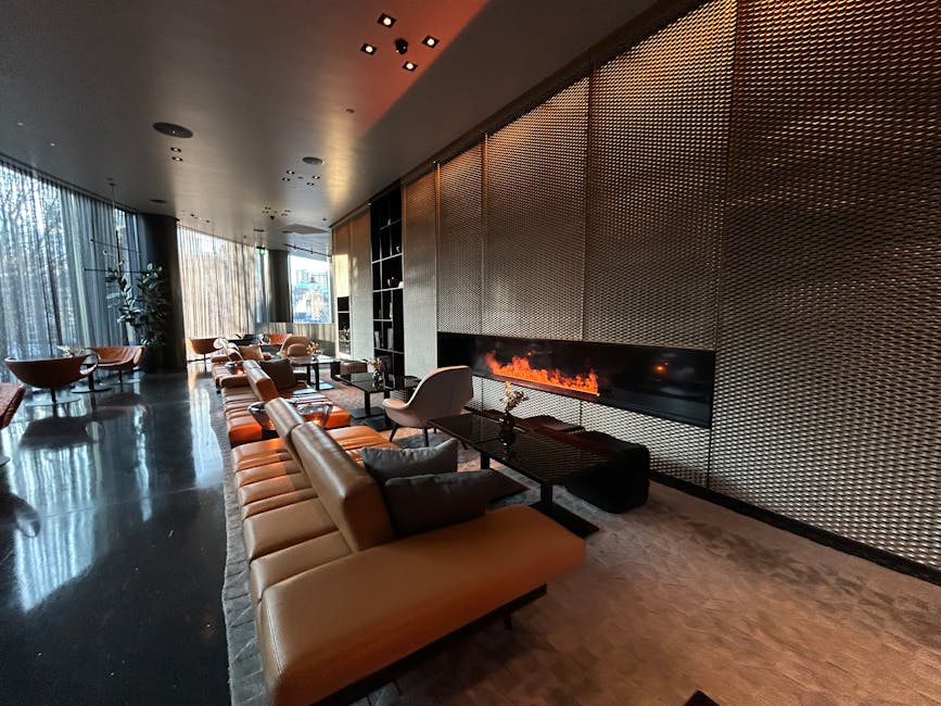 Luxurious modern hotel lounge featuring a sleek design and warm fireplace.