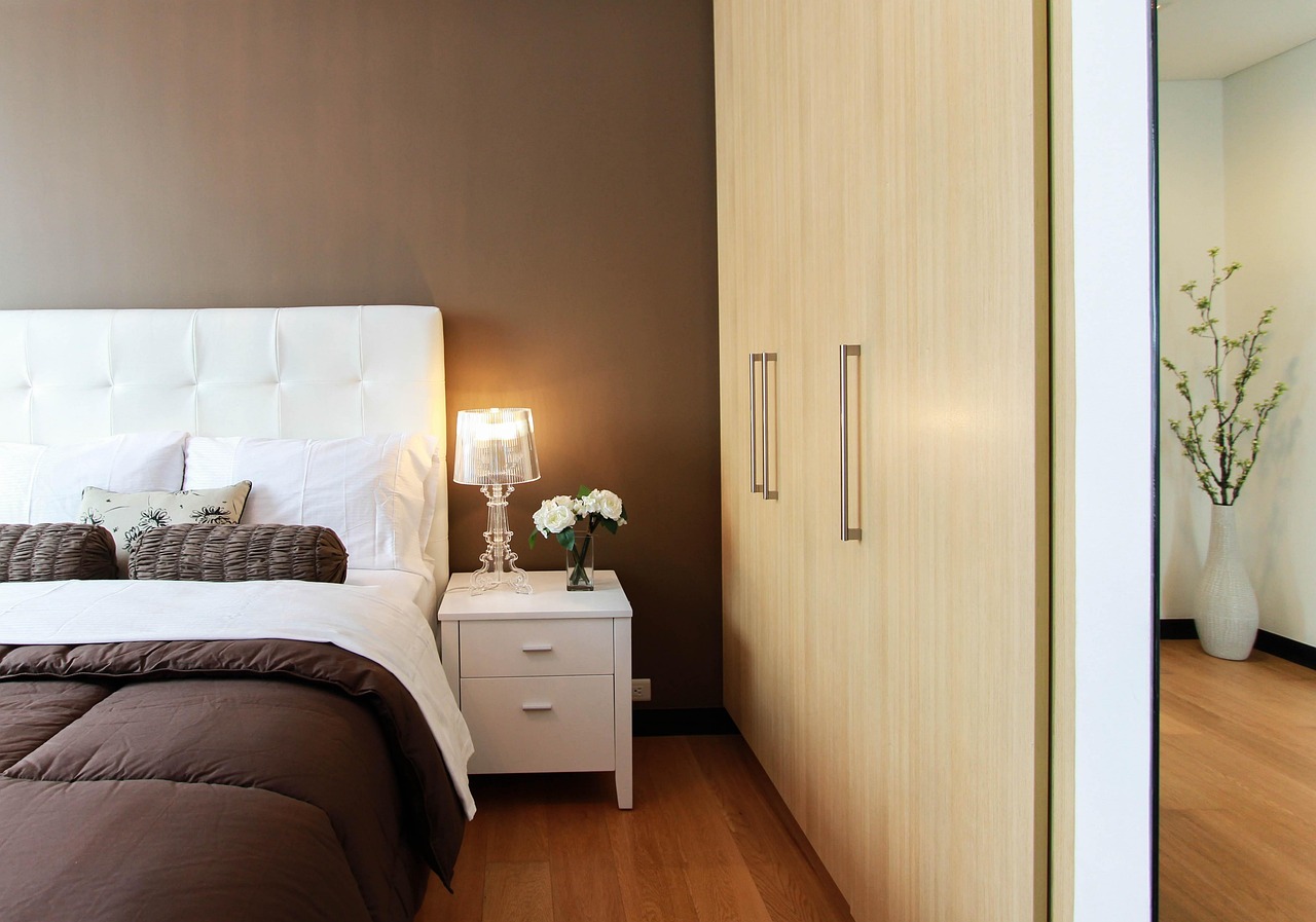 modern hotel bedroom with smart bedside table and integrated charging