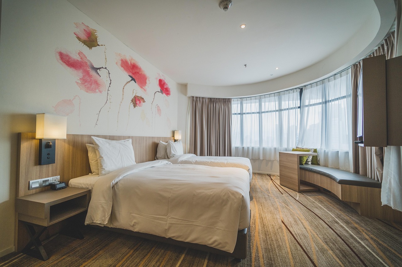 modern hotel suite bed with custom headboard and crisp white linens