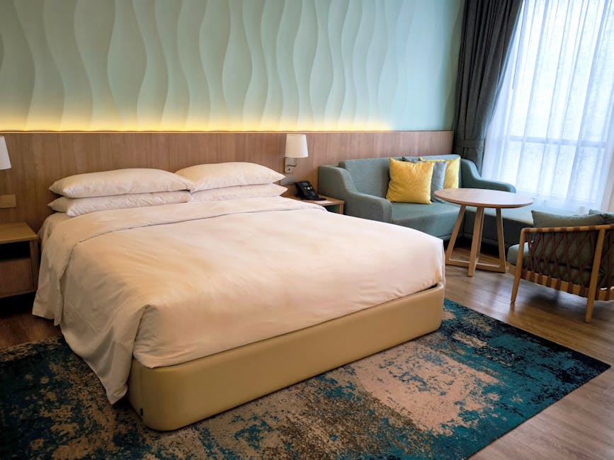 Spacious hotel room featuring a comfy bed, stylish furniture, and elegant lighting for a luxurious stay.