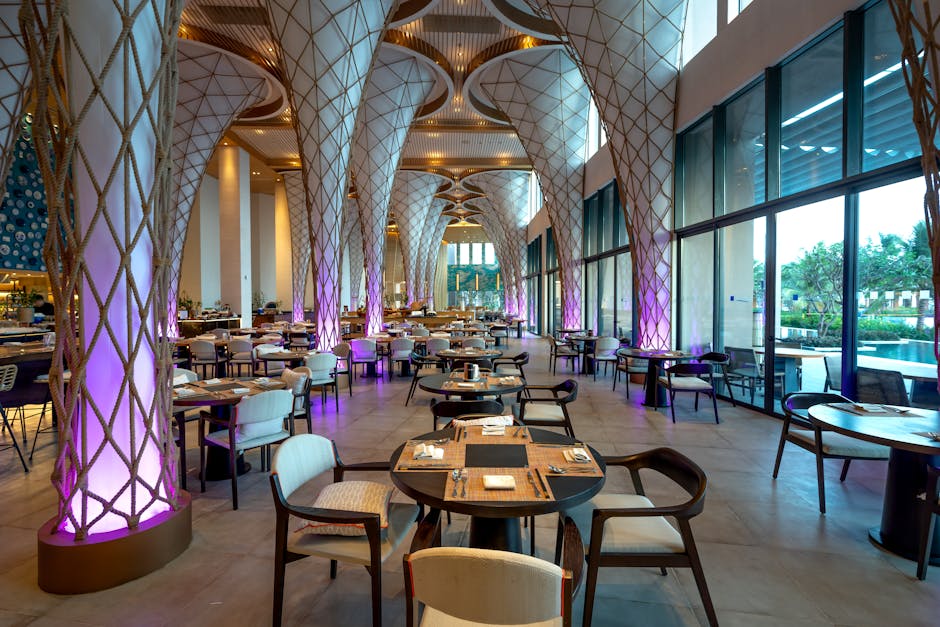 Spacious modern restaurant interior with unique architectural design and ambient lighting.
