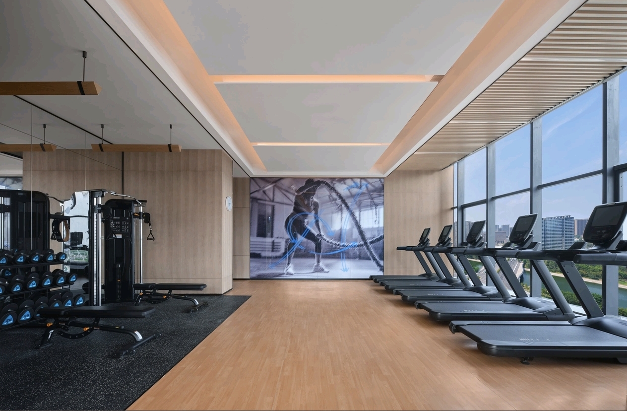 24-hour fitness gym with glass wall interior at DoubleTree Zhengzhou East