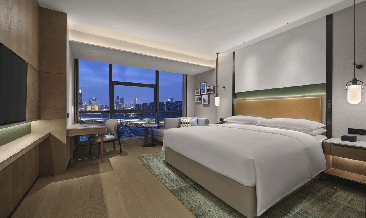 High-floor King bedroom with night city view at DoubleTree Zhengzhou East