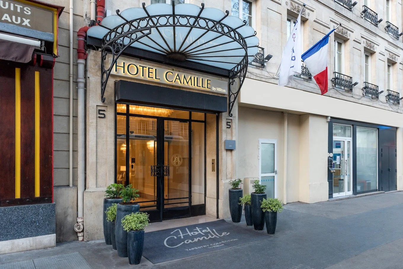 Flag and gate decoration at Hotel Camille Paris entrance