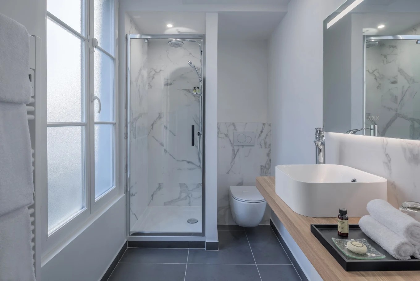 Marble wall guest bathroom at Hotel Camille Paris