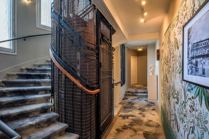 Original French timber stairwell corridor at Hotel Camille Paris