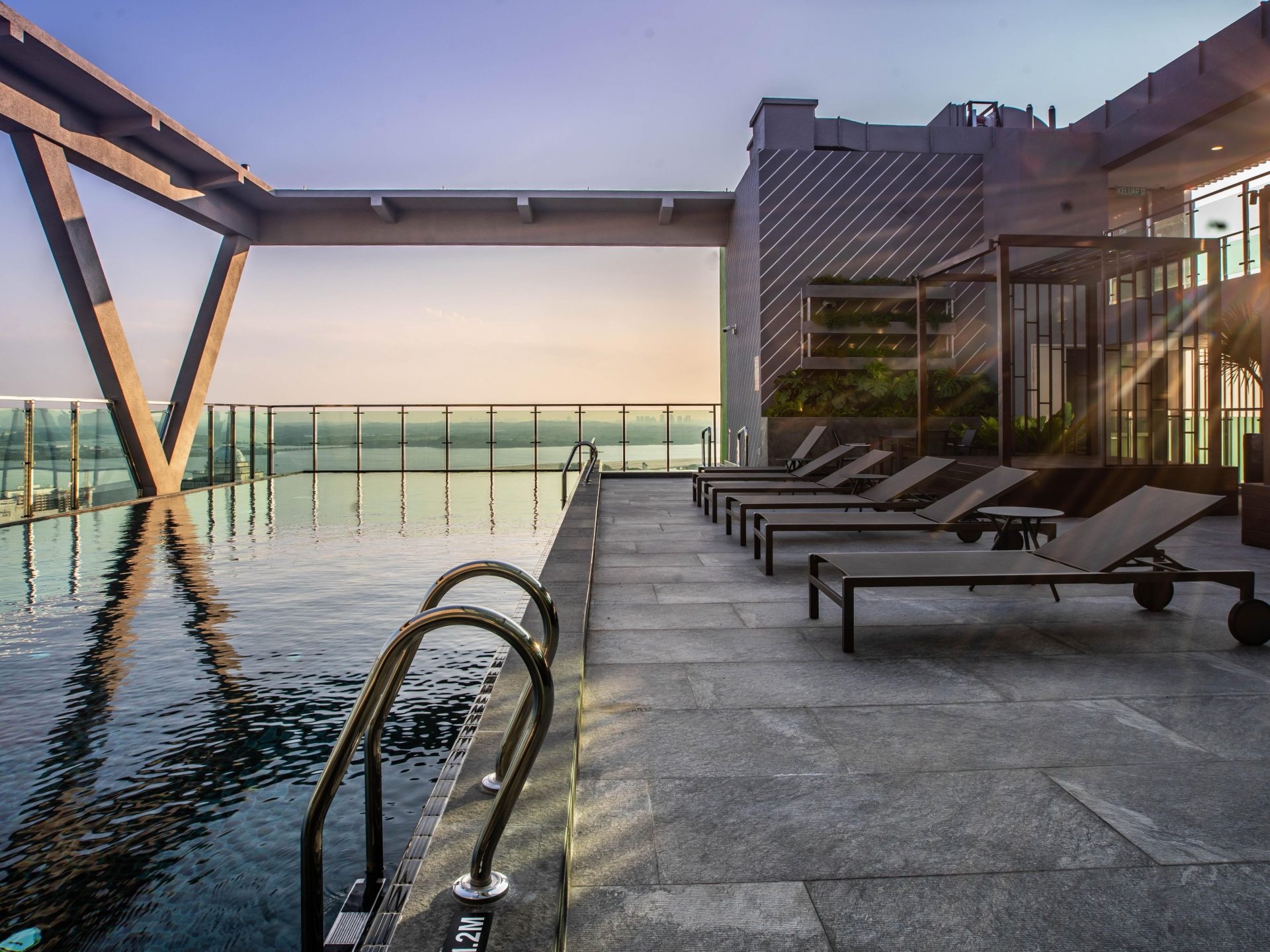 Holiday Inn Johor Bahru City Centre rooftop infinity swimming pool terrace — outdoor furniture by Zhobai