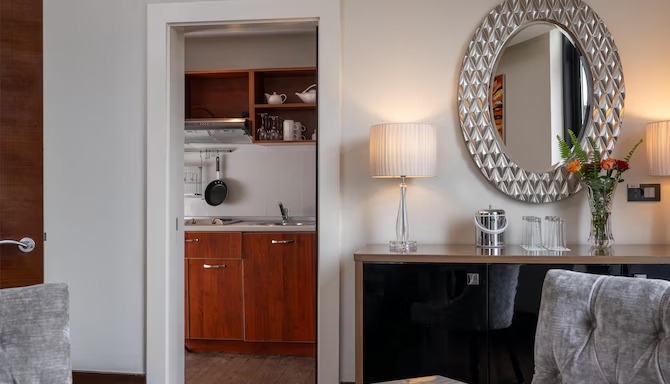 Radisson Blu Addis Ababa room kitchenette and vanity area — suite furniture by Zhobai