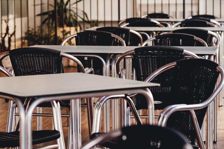 A detailed close-up of a commercial grade furniture for hotels, specifically a restaurant dining chair with visible reinforced joinery and durable fabric upholstery.