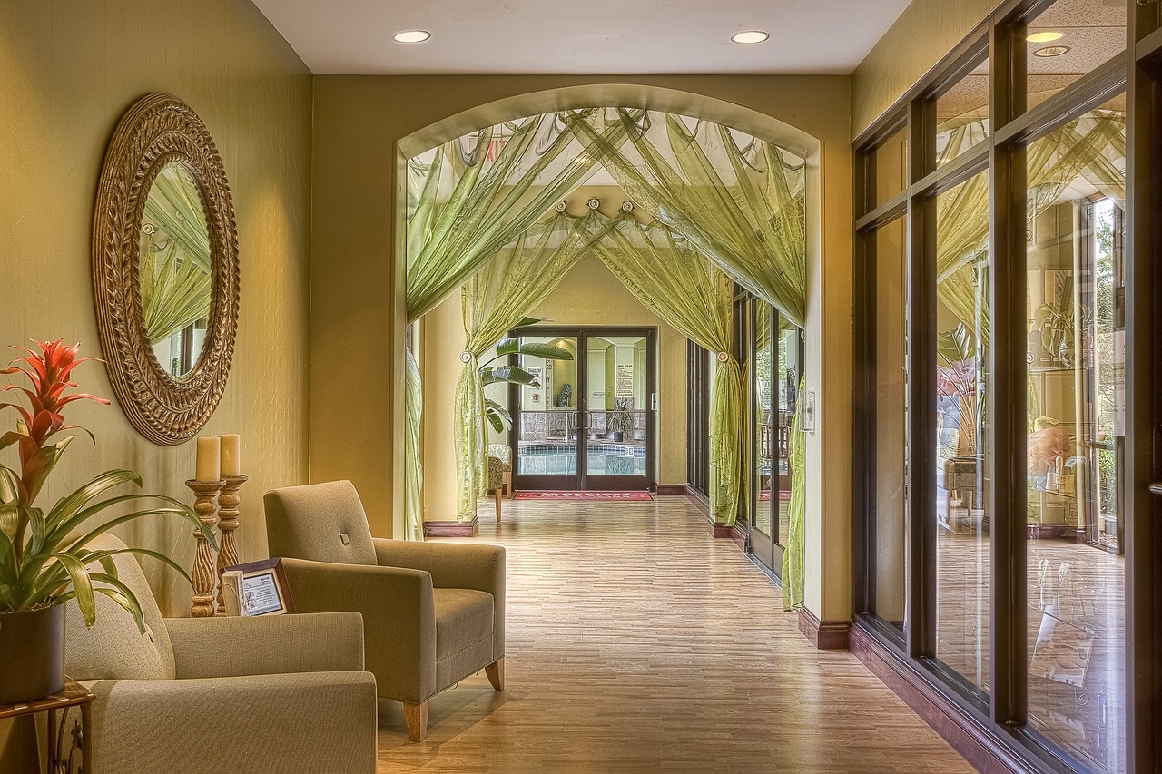 A vibrant hotel lobby with modular seating pods in earthy tones, a large biophilic wall installation, and integrated charging points, showcasing Biophilic Hotel Interior Design UAE.