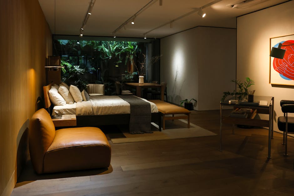 A well-appointed hotel suite with durable, custom-made furniture, including a solid wood media console and a sophisticated linen sofa, demonstrating long-term FF&E investment.
