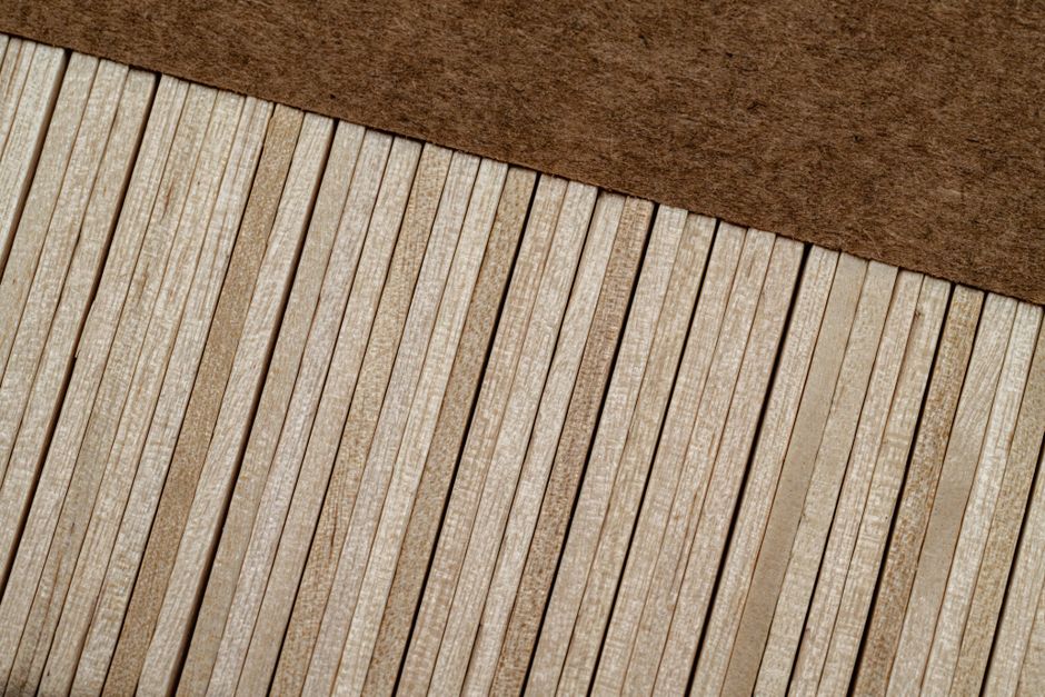 An artistic close-up shot of parallel wooden planks creating a textured pattern.