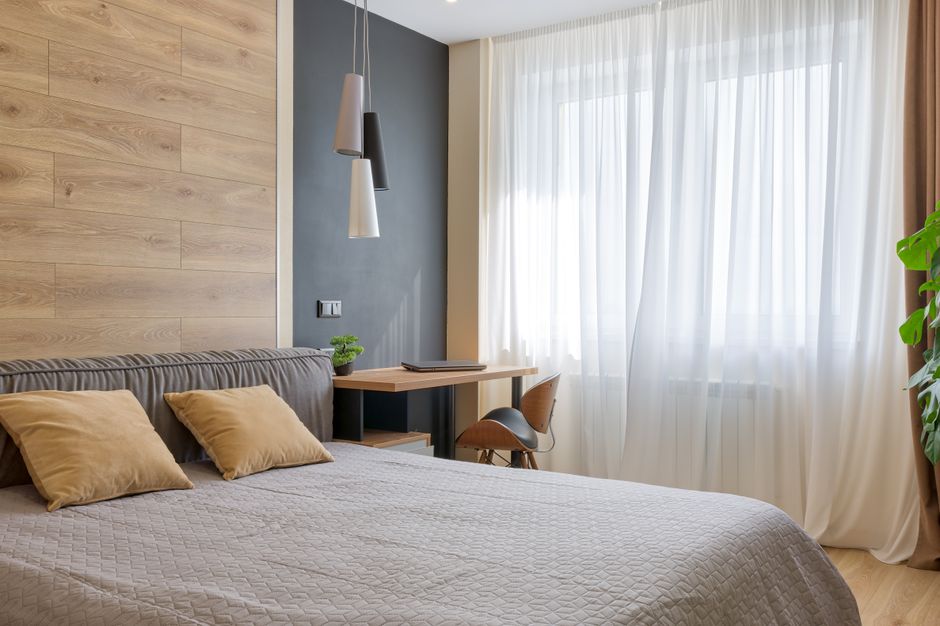 Bright and airy bedroom featuring modern design elements, wooden accents, and natural lighting.