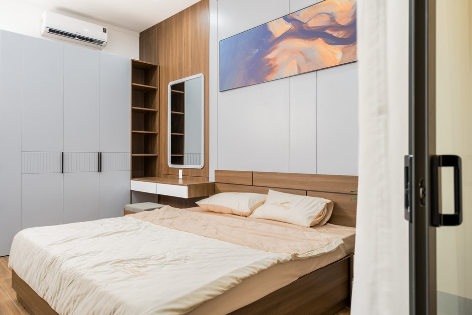 Cozy modern bedroom with neutral tones and minimalist decor, perfect for urban living.