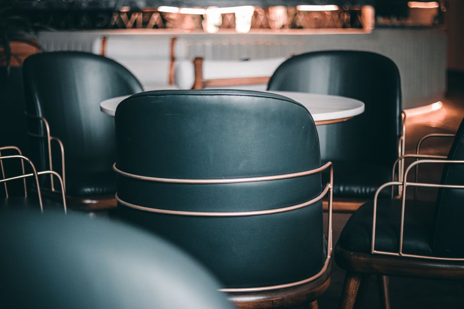 Explore this trendy coffee shop's elegant seating area featuring stylish chairs and tables in an inviting ambiance.