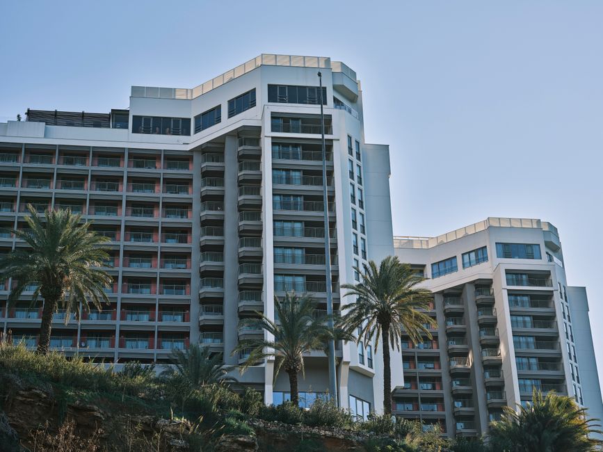 Architectural rendering of a modern luxury hotel, illustrating a significant hotel building cost.