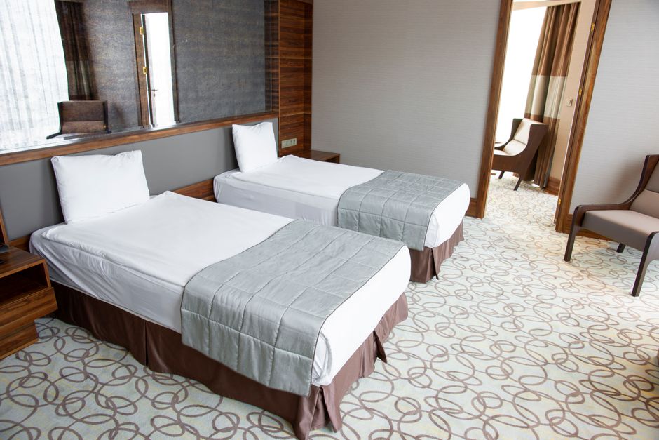 Skilled craftsmen assembling custom hotel furniture, reflecting the quality behind the price list.