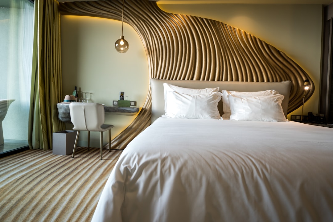 Hotel guestroom with custom bed, nightstand, and desk showcasing contract-grade furniture for hotel FF&E budget Middle East planning