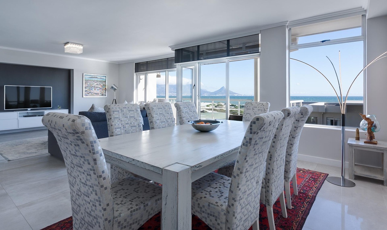 hotel staff cleaning restaurant tables and chairs in a bright dining room