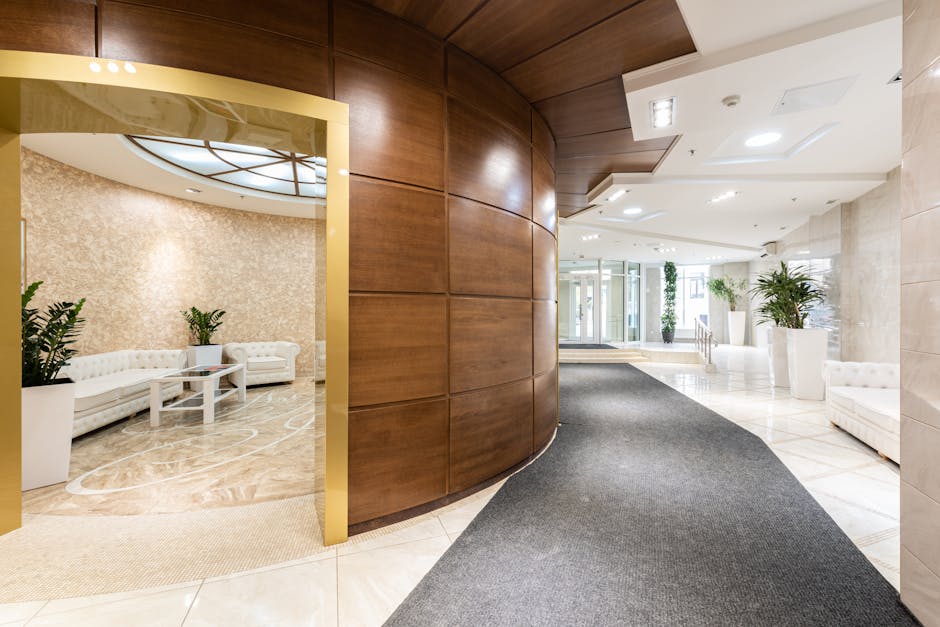 Interior of spacious lobby with white furniture and comfortable sofas placed in contemporary business center in daylight