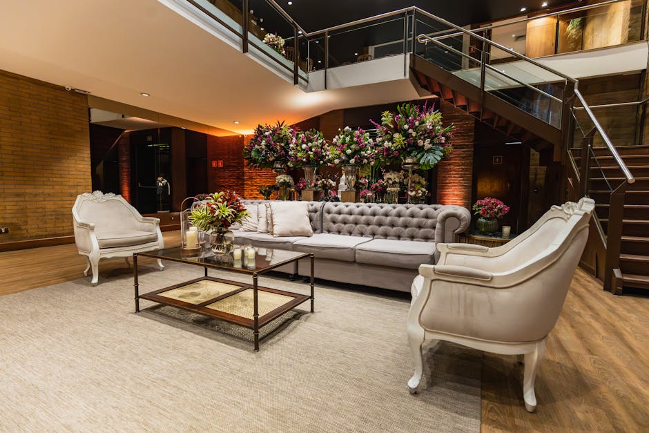 Luxurious hotel lobby featuring a classic sofa set and elegant floral arrangements.