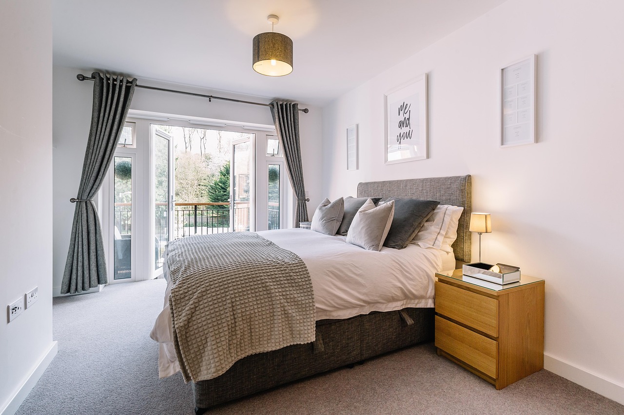 minimalist hotel guestroom interior with custom wooden furniture and a large window view