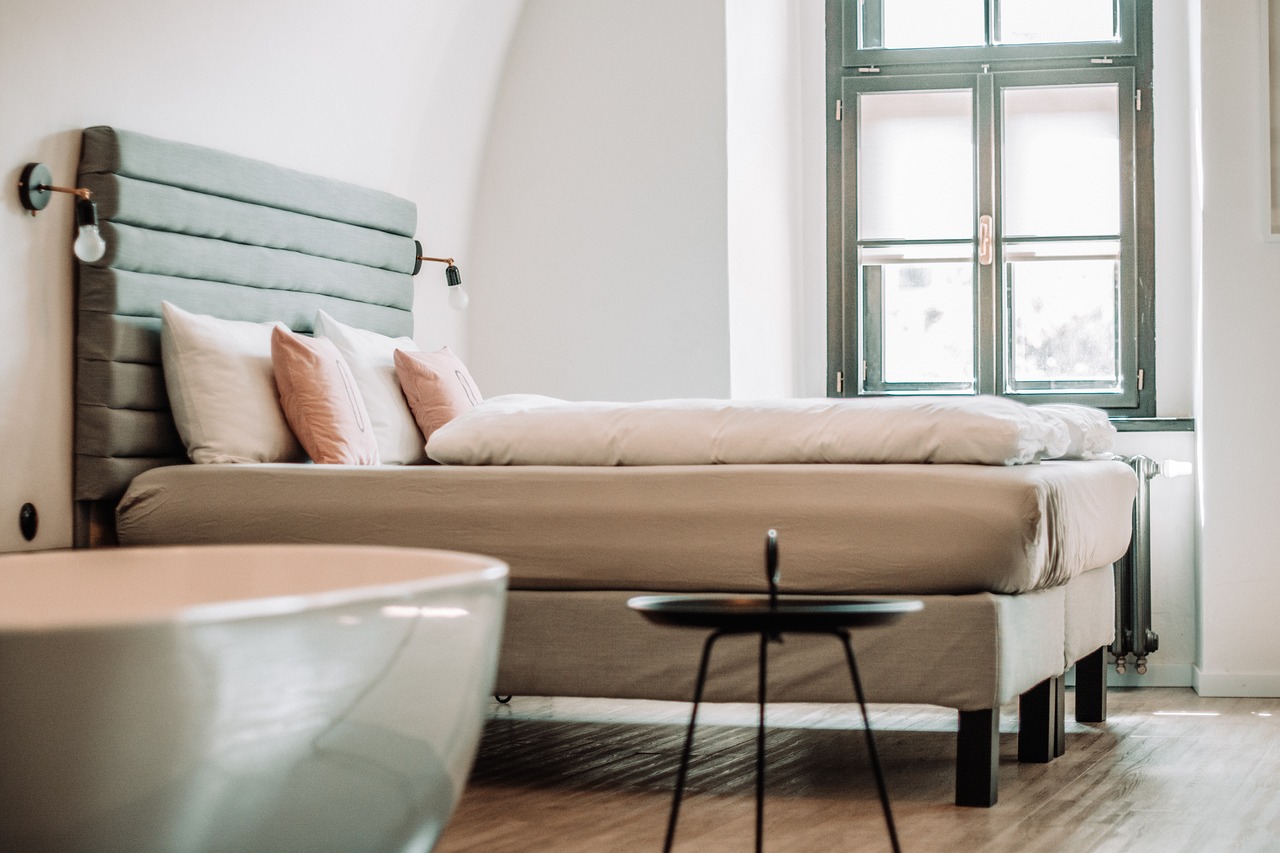 minimalist hotel guestroom with integrated technology and custom wooden furniture