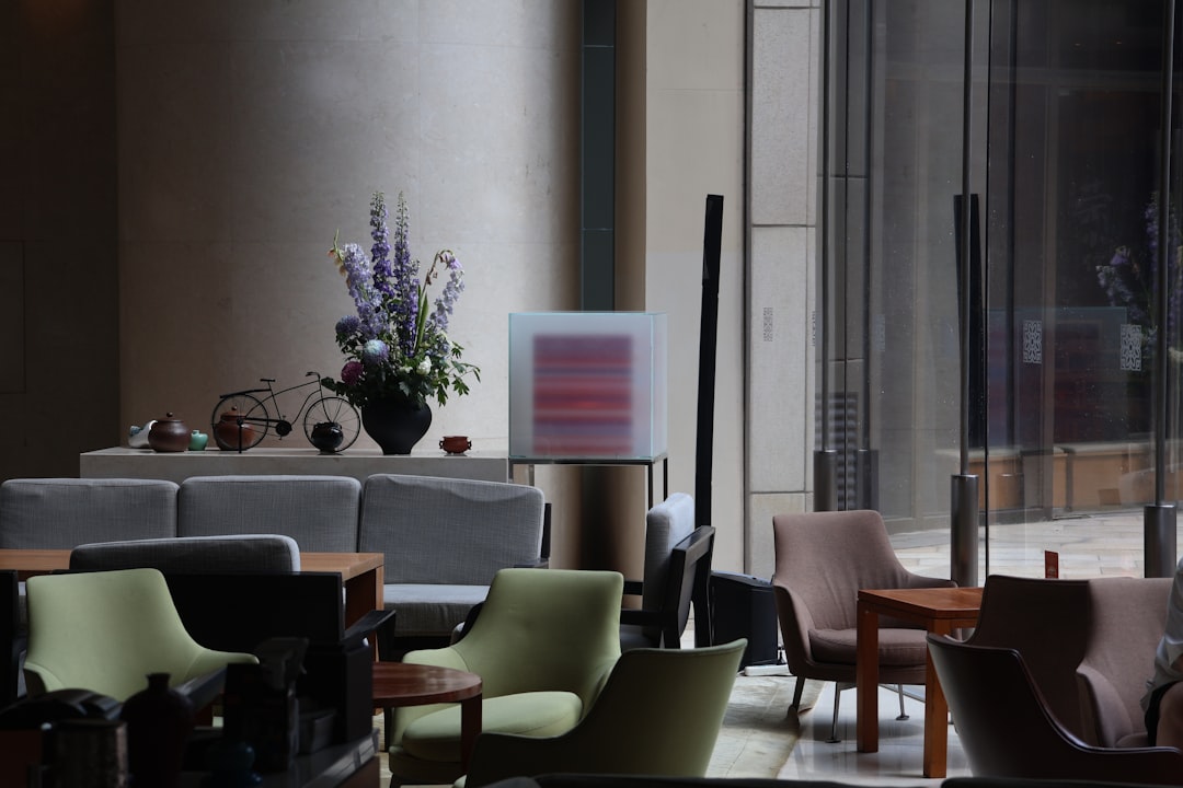Modern lounge area with comfortable seating and floral arrangement.