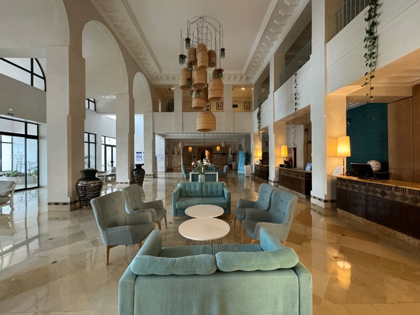 Spacious and elegant hotel lobby featuring modern furniture, lighting, and decor reflecting luxury interior design.