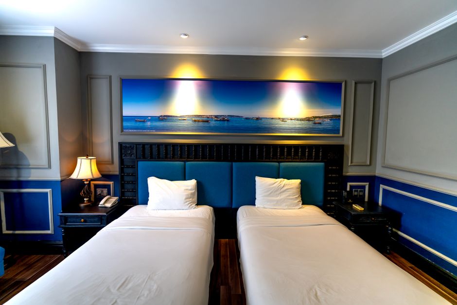 Stylish hotel room featuring twin beds and modern decor perfect for relaxation and comfort.