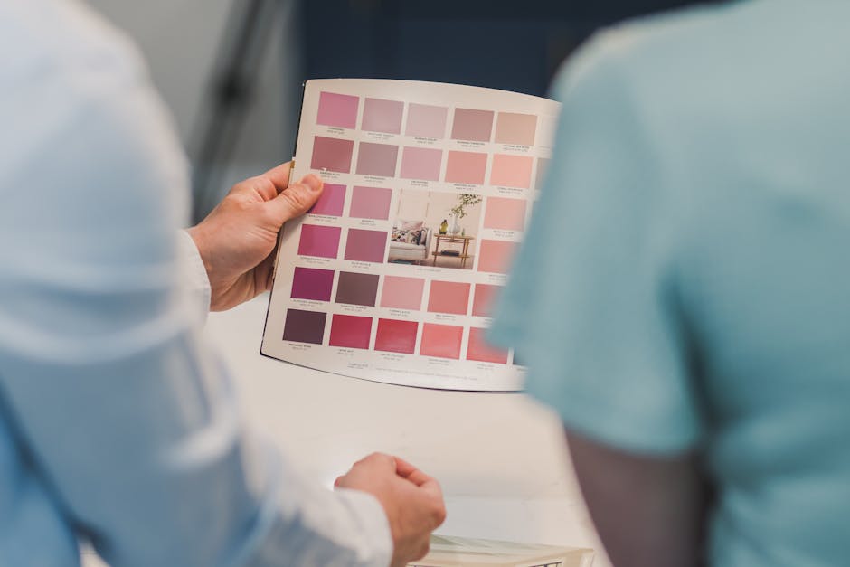 Two individuals evaluate a color palette brochure for interior design planning.