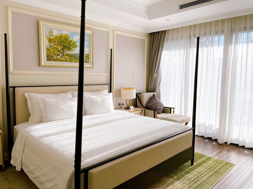 Bright bedroom featuring modern design with large windows and cozy furnishings.
