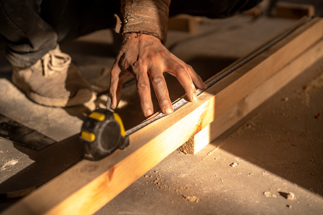 Concealed door hinge installation during luxury hotel bespoke millwork assembly