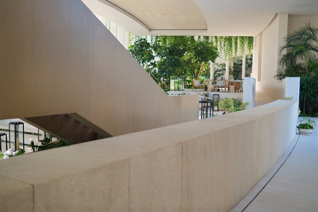 Modern building interior with beige walls and green plants.
